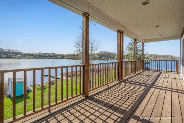 deck featuring a water view and a yard