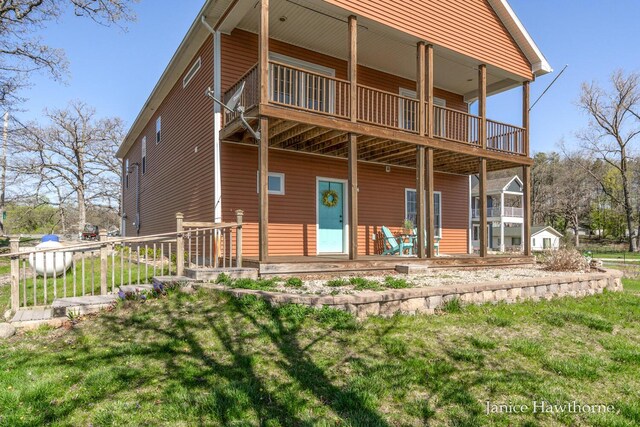 back of property featuring a lawn