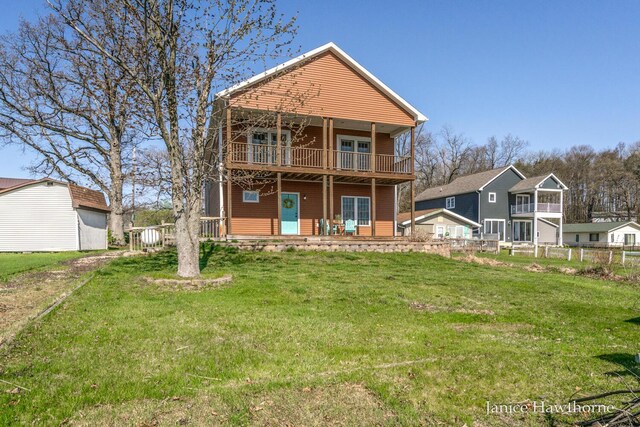 rear view of house with a balcony and covered porch