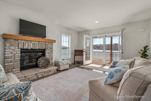 living room featuring a brick fireplace and recessed lighting