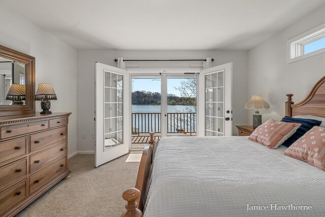 bedroom featuring french doors, access to exterior, light carpet, a water view, and baseboards