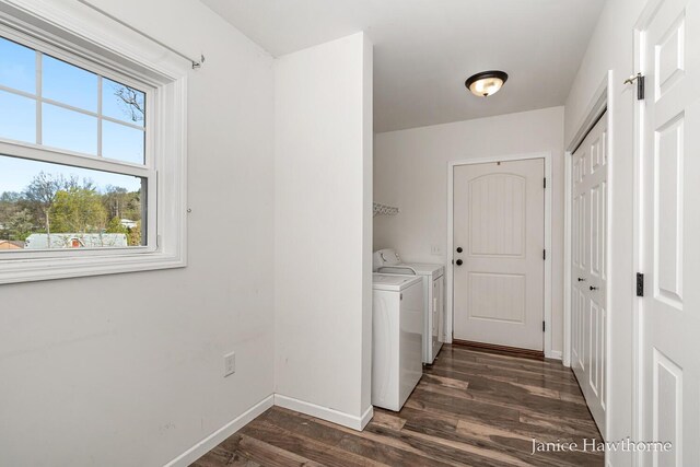 laundry area featuring washing machine and clothes dryer, dark wood-style flooring, and baseboards