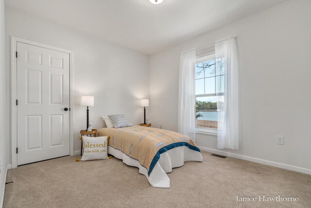 carpeted bedroom featuring baseboards