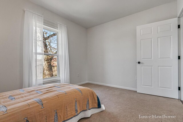 carpeted bedroom with baseboards