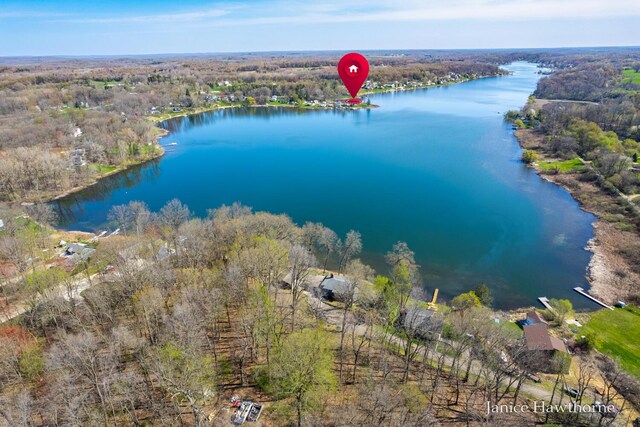 bird's eye view of a large body of water and a heavily wooded area