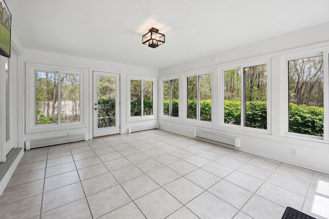 unfurnished sunroom with a baseboard heating unit and tile patterned floors