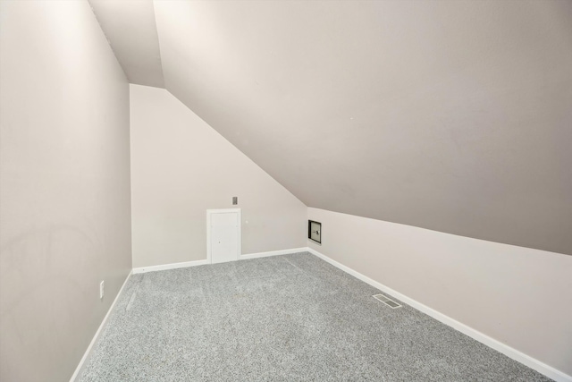 additional living space with lofted ceiling, carpet flooring, and baseboards