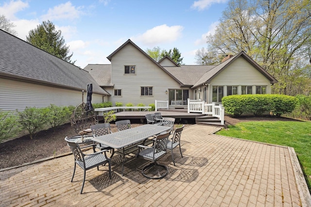 view of patio with outdoor dining space and a wooden deck