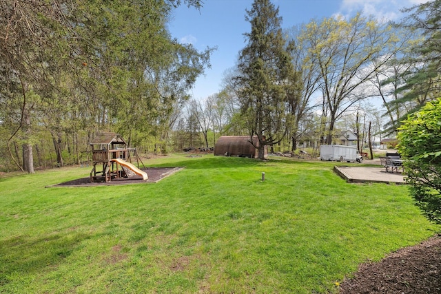 view of green lawn with a playground
