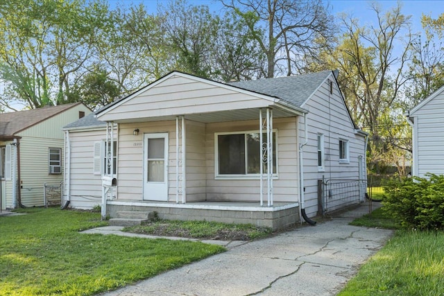 12855 Couwlier Ave, Warren, MI 48089 - view of front of property featuring covered porch, a front lawn, and roof with shingles