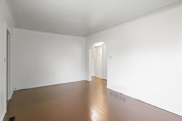 12855 Couwlier Ave, Warren, MI 48089 - empty room with arched walkways and wood finished floors