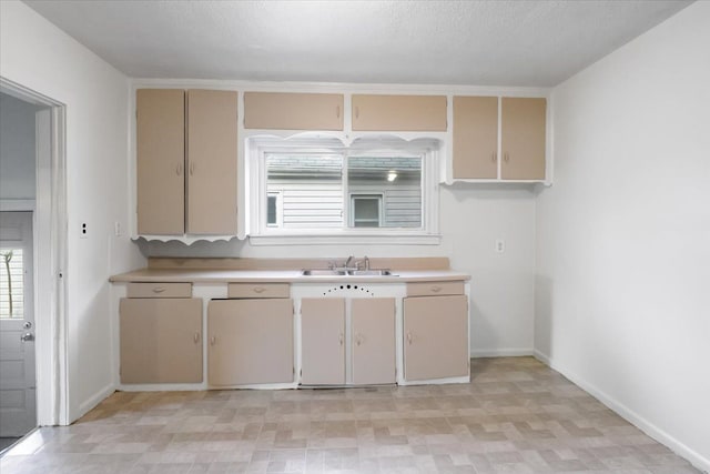12855 Couwlier Ave, Warren, MI 48089 - kitchen featuring a sink, light countertops, cream cabinets, and baseboards