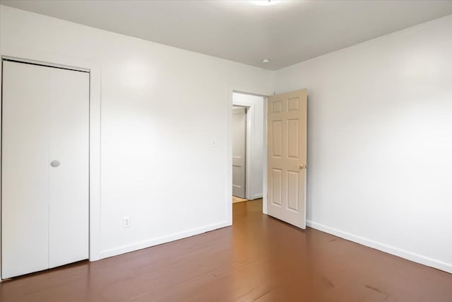 12855 Couwlier Ave, Warren, MI 48089 - unfurnished bedroom with baseboards, a closet, and wood finished floors