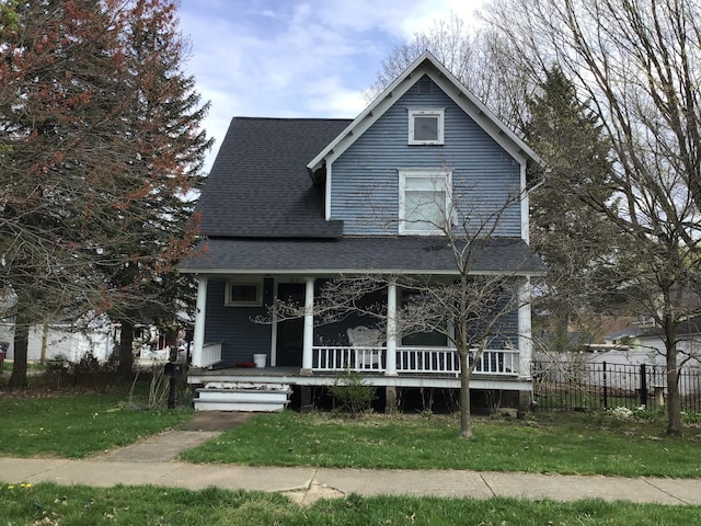 view of front of home featuring covered porch and roof with shingles