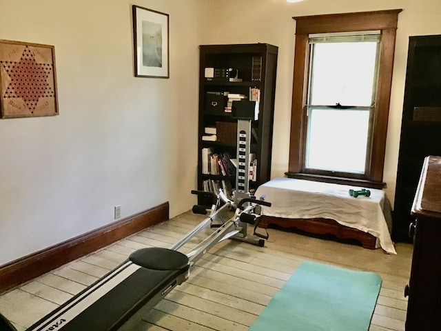 workout area with hardwood / wood-style floors