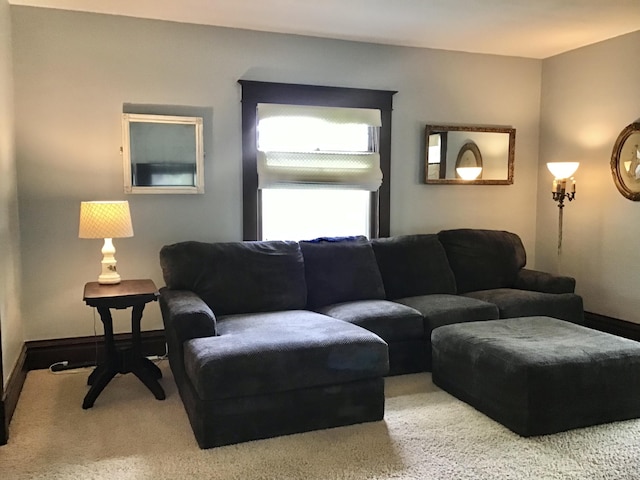 carpeted living room featuring baseboards