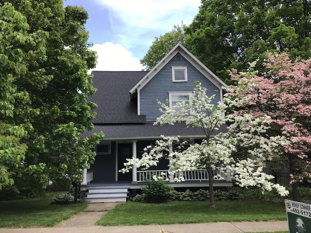 315 S Michigan Ave, Vicksburg, MI 49097 - view of front of house with a shingled roof, covered porch, and a front lawn