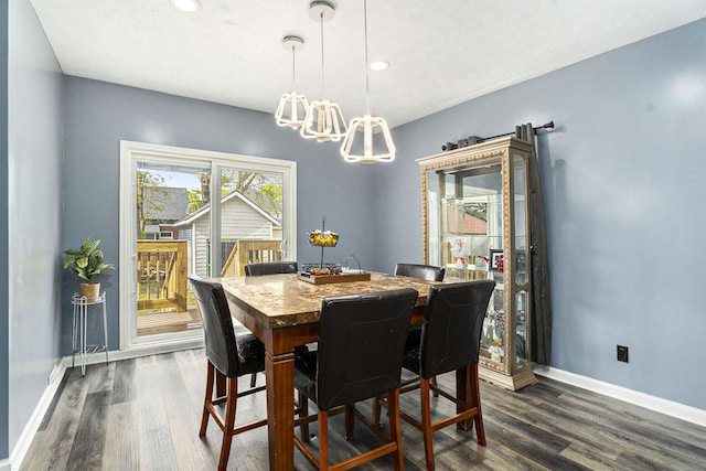 dining space featuring a chandelier, dark wood-style flooring, baseboards, and recessed lighting