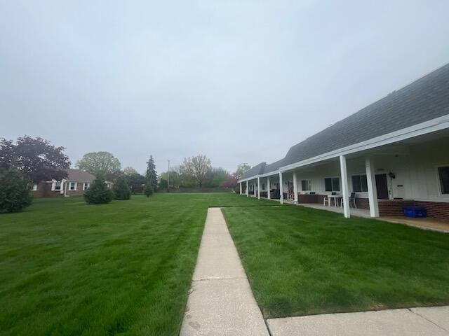 23004 Doremus St Unit 2, Saint Clair Shores, MI 48080 - view of grassy yard with a patio