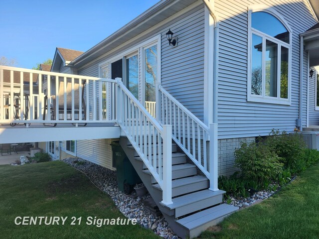 view of home's exterior featuring a lawn and a deck