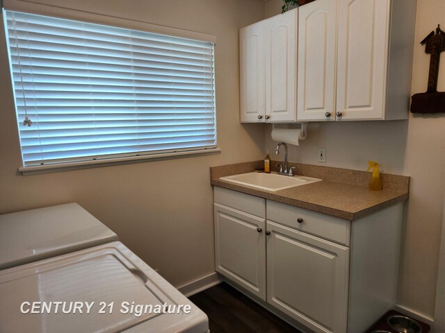 washroom with independent washer and dryer, cabinet space, baseboards, dark wood-style flooring, and healthy amount of natural light