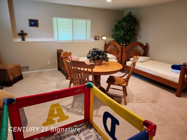 dining room featuring carpet flooring and baseboards