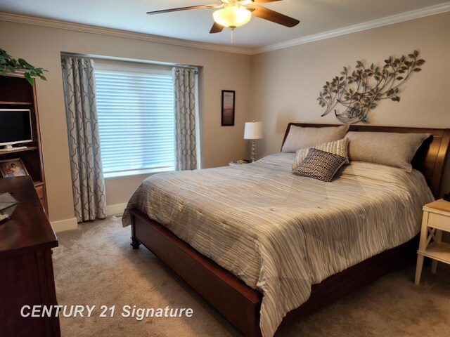 bedroom featuring carpet, ornamental molding, baseboards, and a ceiling fan
