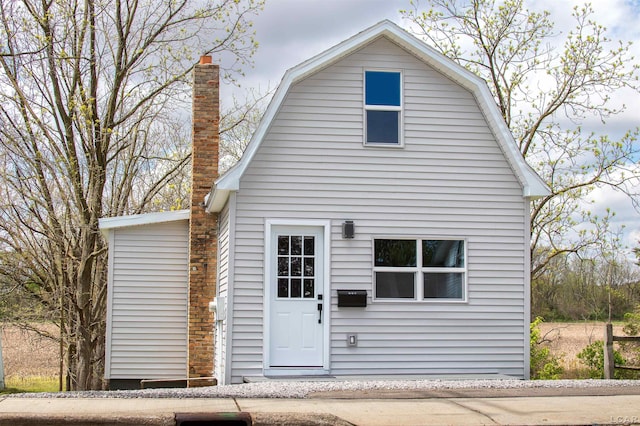 807 N St, Morenci, MI 49256 - rear view of property with a gambrel roof and a chimney