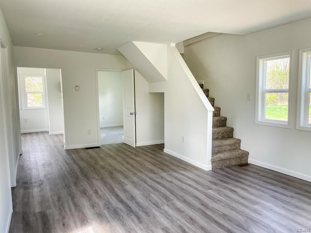 807 N St, Morenci, MI 49256 - unfurnished living room with plenty of natural light, wood finished floors, stairs, and baseboards