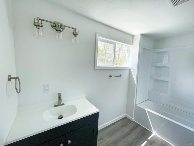 807 N St, Morenci, MI 49256 - full bath with wood finished floors, vanity, tub / shower combination, and baseboards