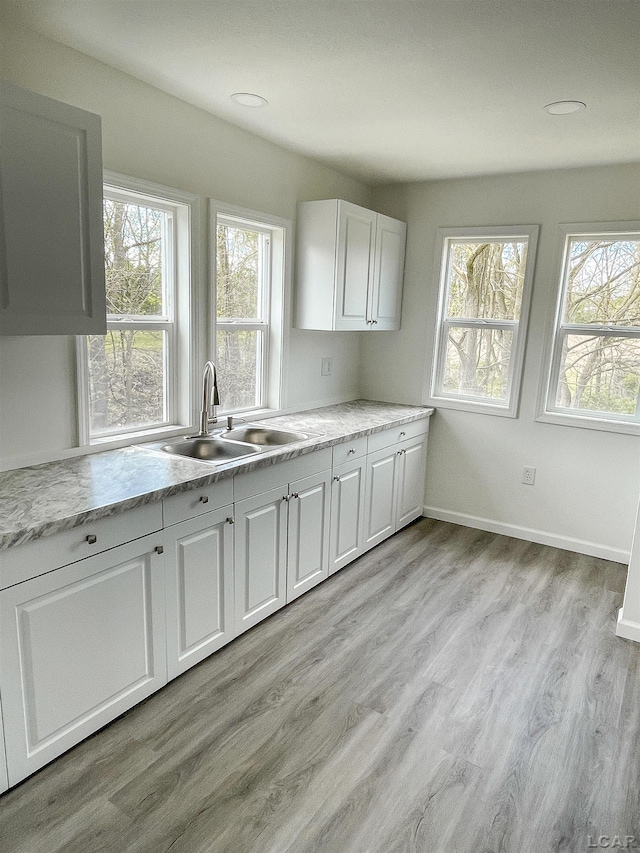 807 N St, Morenci, MI 49256 - kitchen with a sink, plenty of natural light, and white cabinets