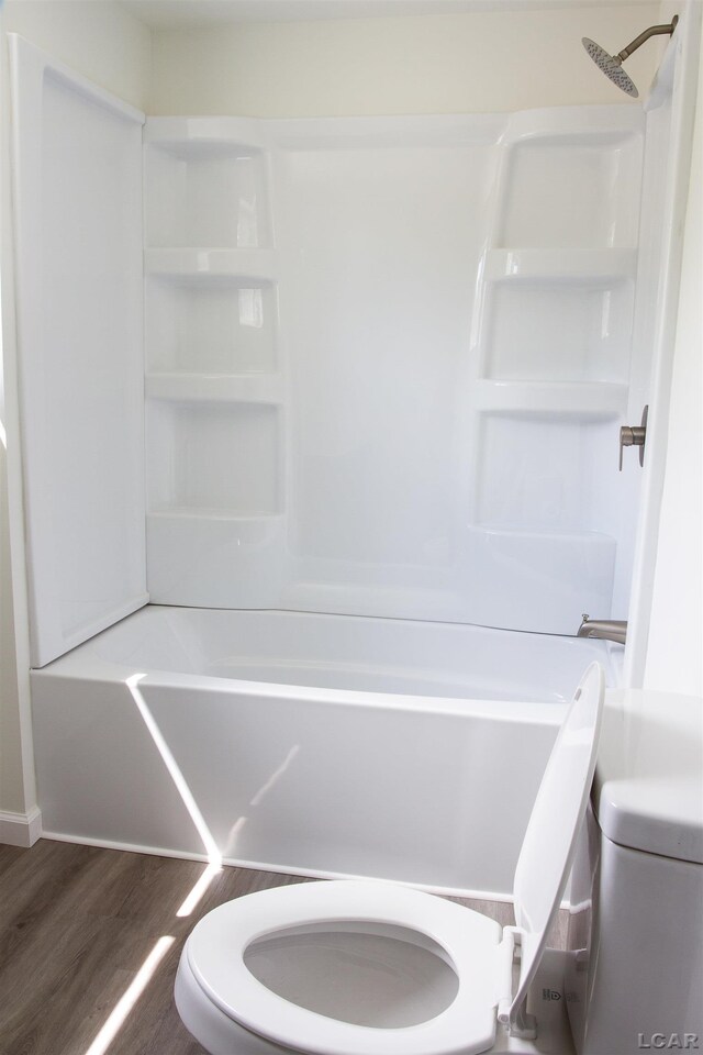 807 N St, Morenci, MI 49256 - full bathroom with toilet, wood finished floors, and washtub / shower combination