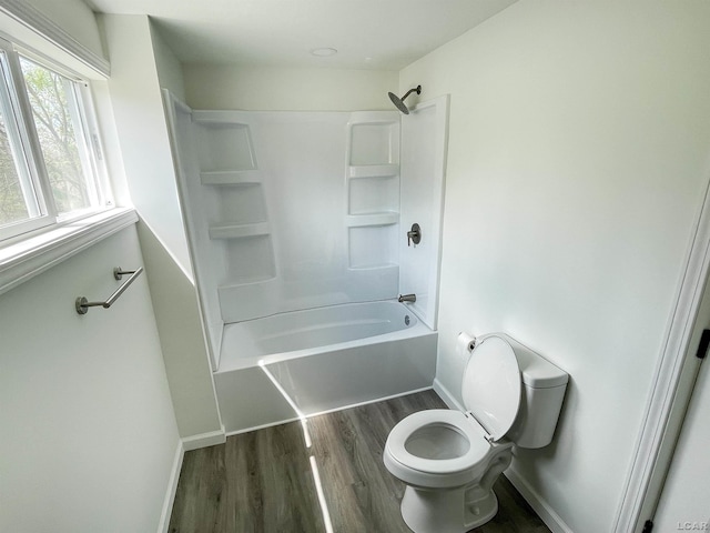 807 N St, Morenci, MI 49256 - full bath with baseboards, wood finished floors, toilet, and washtub / shower combination