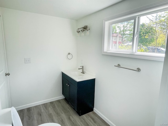 807 N St, Morenci, MI 49256 - bathroom featuring healthy amount of natural light, wood finished floors, vanity, and baseboards