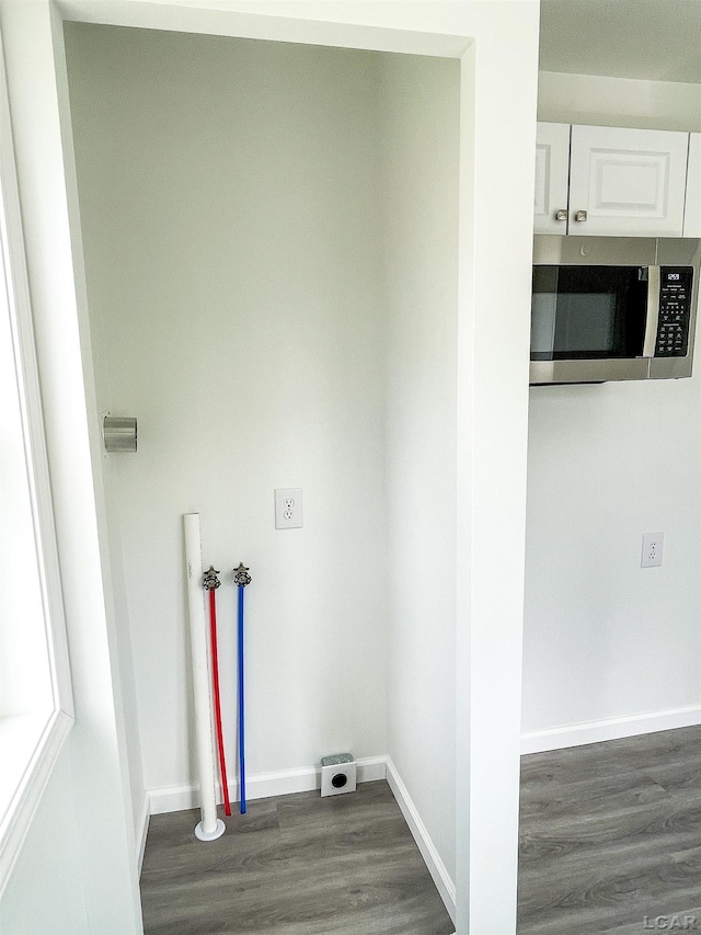 807 N St, Morenci, MI 49256 - washroom with dark wood-type flooring, baseboards, and electric dryer hookup
