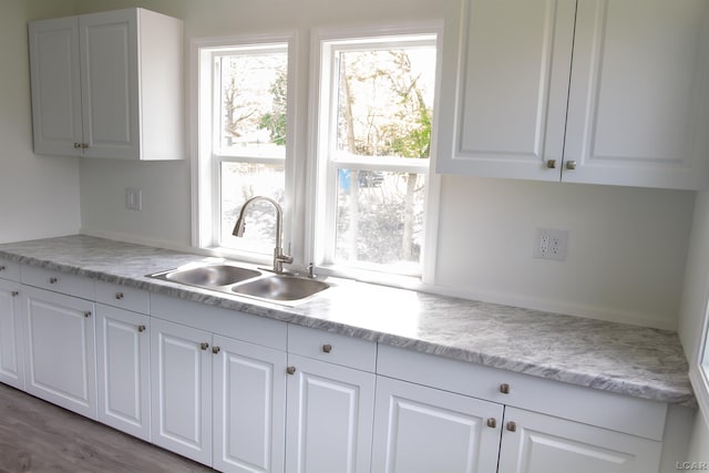 807 N St, Morenci, MI 49256 - kitchen featuring a sink, plenty of natural light, and white cabinets