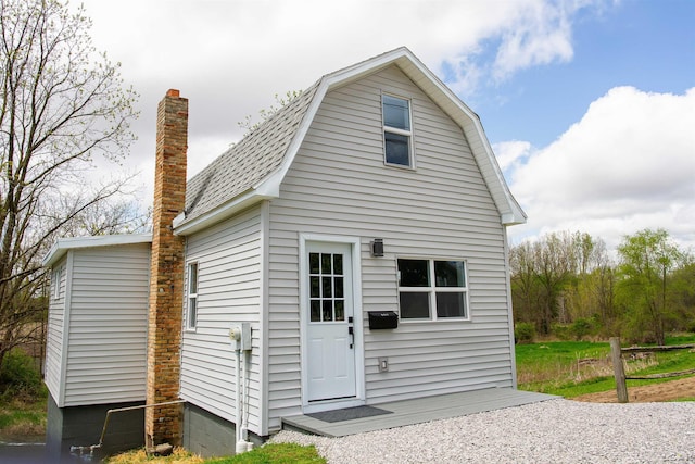 807 N St, Morenci, MI 49256 - back of house featuring a gambrel roof, a shingled roof, and a chimney