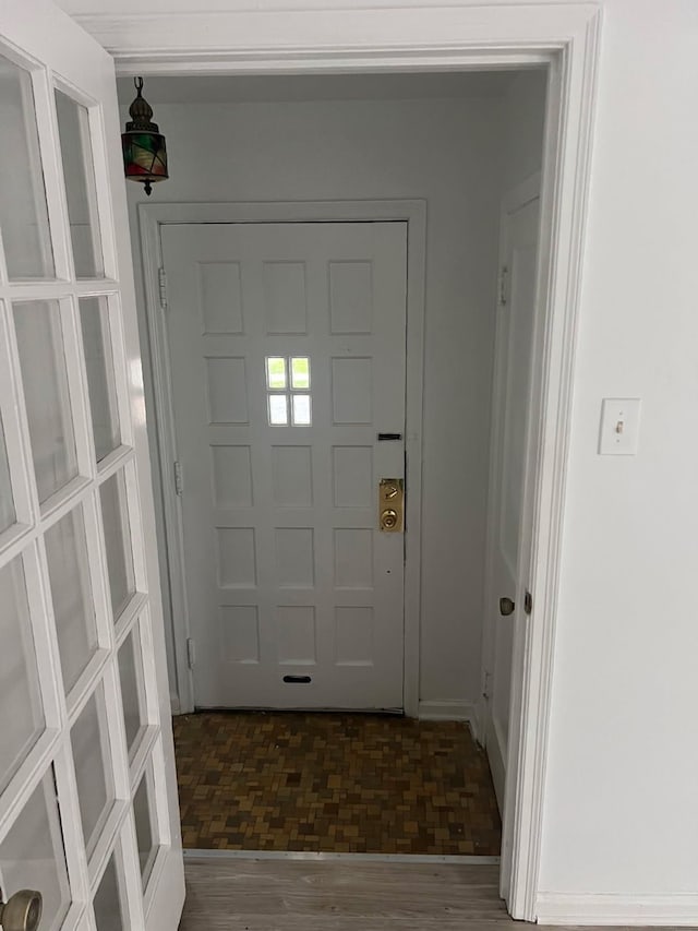 entryway with wood finished floors