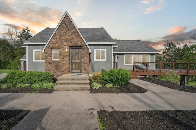 6481 Wardell, West Bloomfield, MI 48324 - english style home featuring stone siding, a shingled roof, and a deck