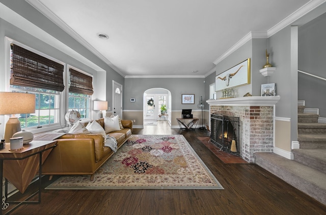 3556 Orchard Lake Rd, Orchard Lake, MI 48324 - living area featuring arched walkways, hardwood / wood-style flooring, a brick fireplace, crown molding, and baseboards