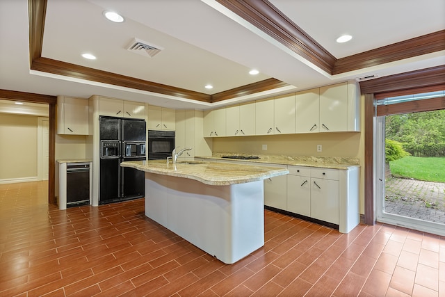 5215 Deer Run Cir, Orchard Lake, MI 48323 - kitchen featuring a tray ceiling, black appliances, crown molding, cream cabinetry, and recessed lighting