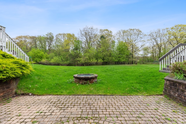 5215 Deer Run Cir, Orchard Lake, MI 48323 - view of green lawn featuring a fire pit and a patio area
