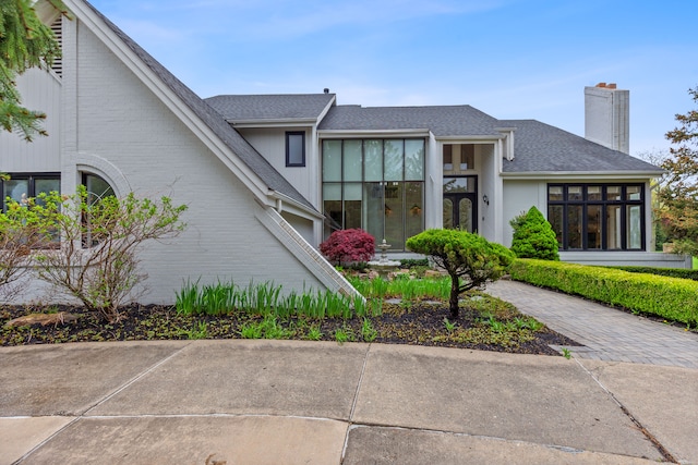 5215 Deer Run Cir, Orchard Lake, MI 48323 - view of front of property featuring a chimney, brick siding, and a shingled roof