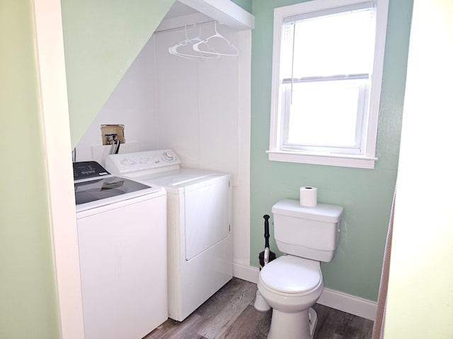 laundry room with washer and clothes dryer, light wood-style floors, and healthy amount of natural light