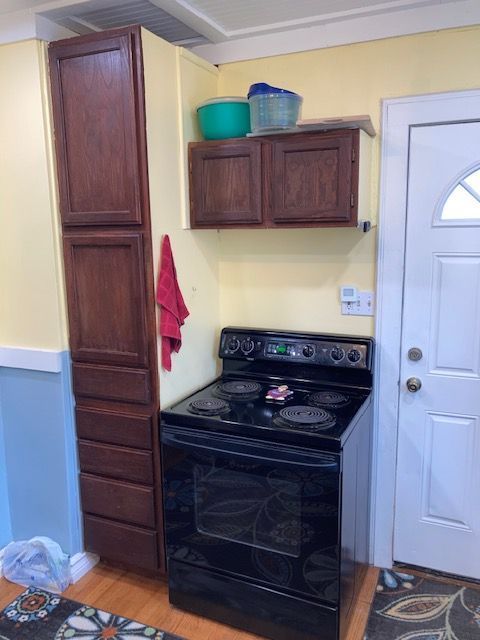 kitchen featuring black / electric stove and light wood-type flooring