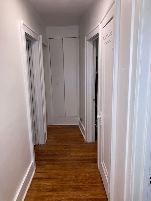 hall featuring wood finished floors and baseboards