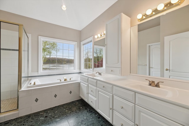 full bath with a garden tub, a stall shower, and double vanity