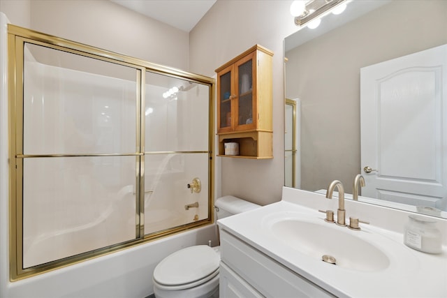 full bathroom with toilet, vanity, and bath / shower combo with glass door