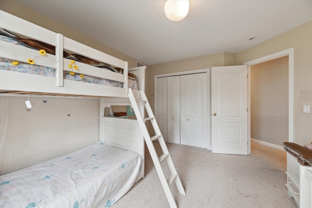 unfurnished bedroom with light carpet, baseboards, and a closet