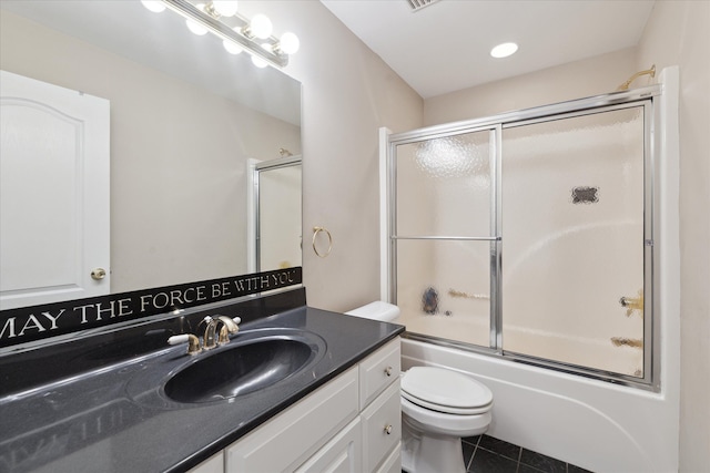 full bathroom with tile patterned flooring, vanity, toilet, and bath / shower combo with glass door